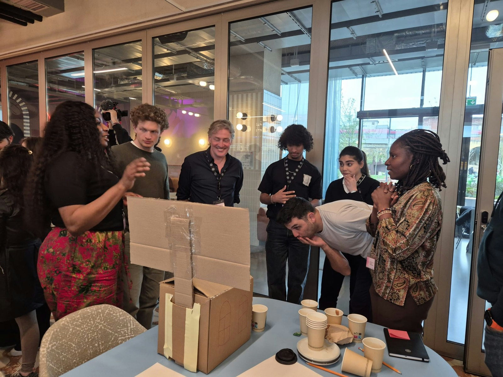 A team presenting their cardboard conversational object at the Better Society Academy in Rome